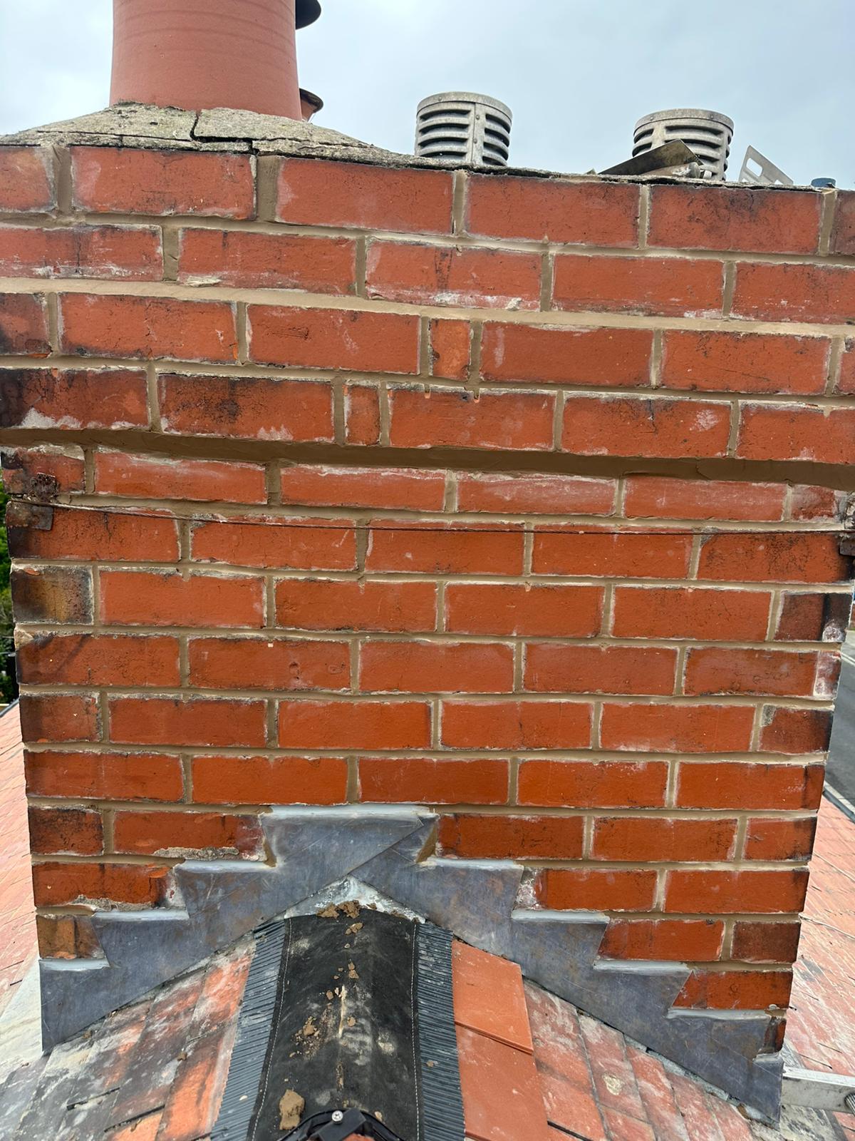Red brick chimney with freshly repointed mortar joints in Blackpool