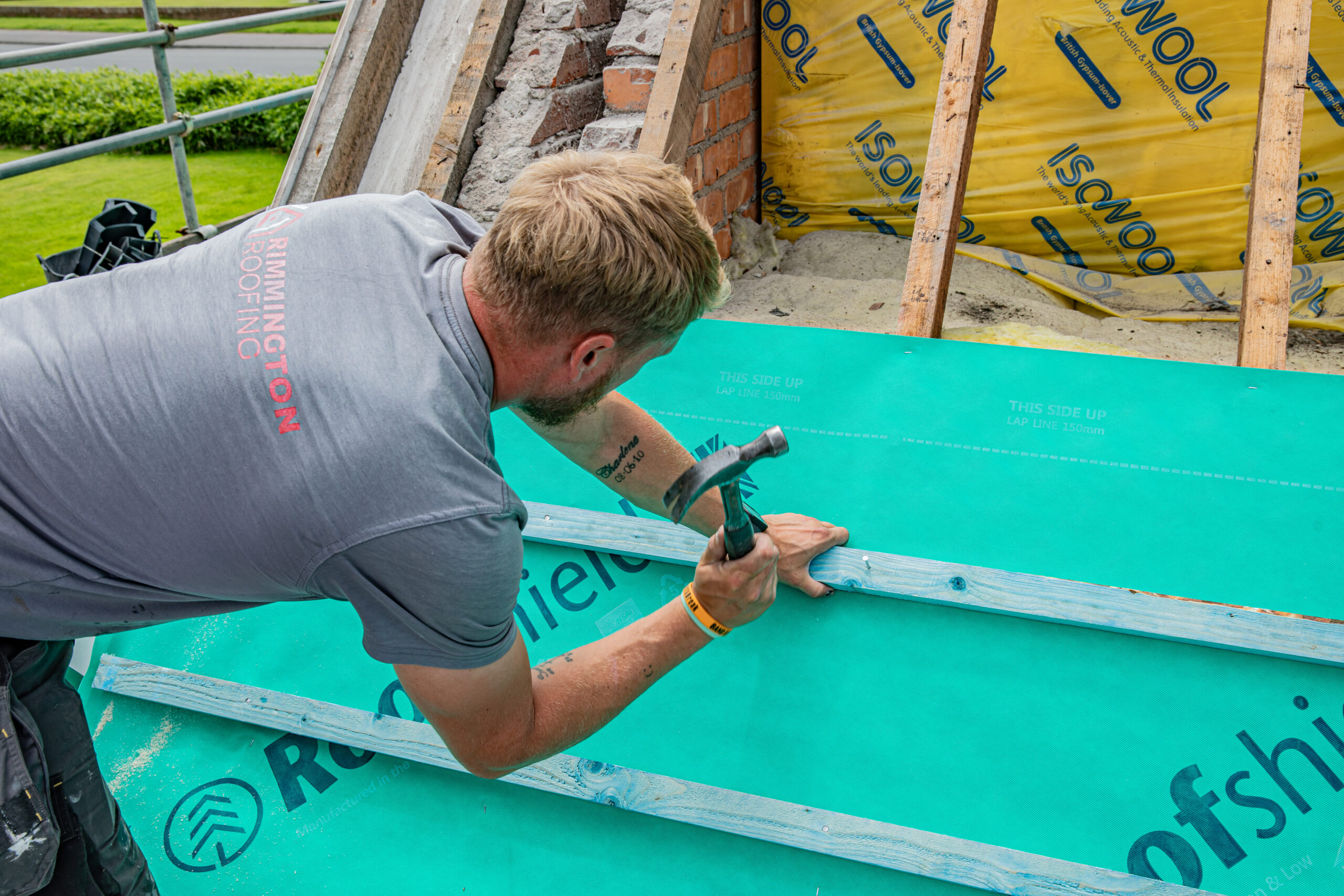 Roofer fixing battens over breathable membrane on a Fylde Coast reroof